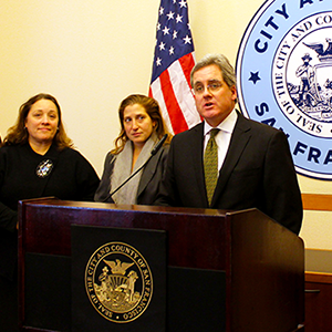 City Attorney Dennis Herrera speaks at a Jan. 16, 2015 news conference after a court ruling holds that the ACCJC engaged in “significant unlawful practices” in reaching its evaluation of City College of San Francisco. To Herrera's left: Deputy City Attorneys To Herrera’s left: Deputy City Attorneys Yvonne Meré and Sara Eisenberg. 